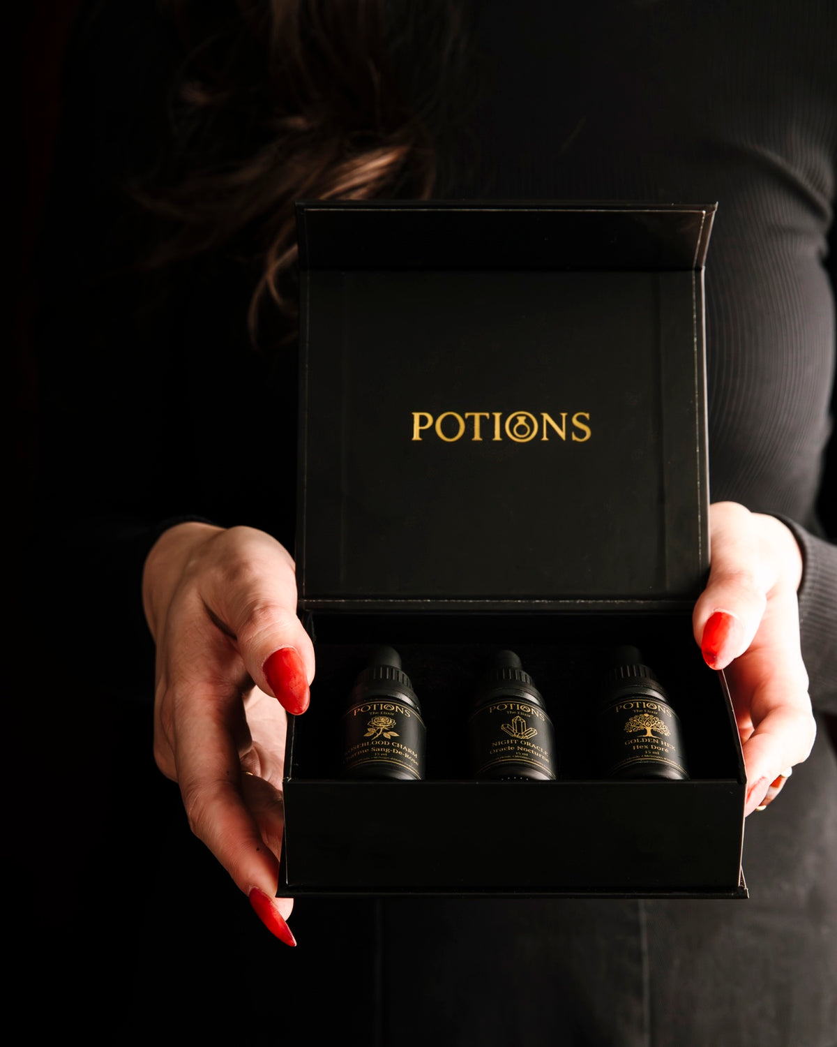 Potions Vault collection — three botanical perfume oils in black luxury presentation box